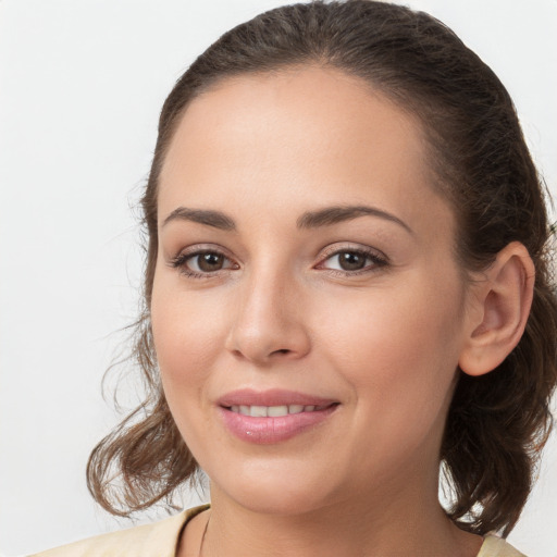 Joyful white young-adult female with medium  brown hair and brown eyes