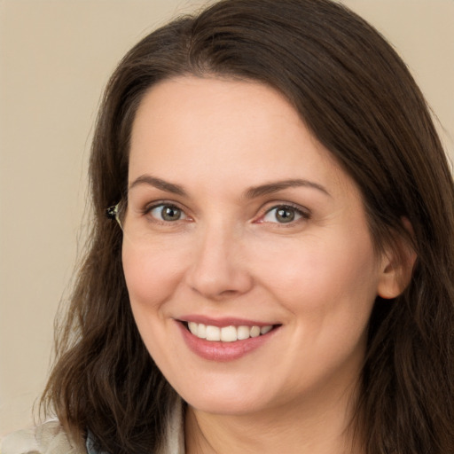 Joyful white young-adult female with long  brown hair and brown eyes