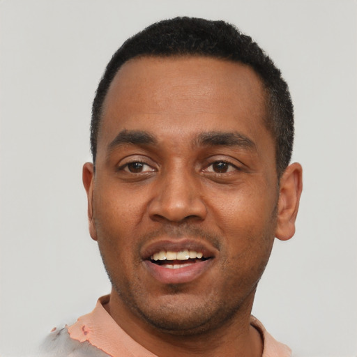 Joyful black young-adult male with short  black hair and brown eyes