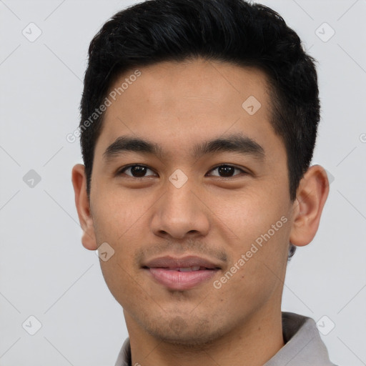 Joyful asian young-adult male with short  black hair and brown eyes