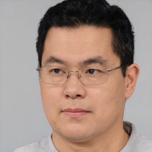 Neutral asian adult male with short  black hair and brown eyes
