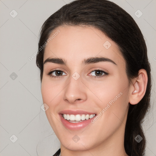 Joyful white young-adult female with medium  brown hair and brown eyes