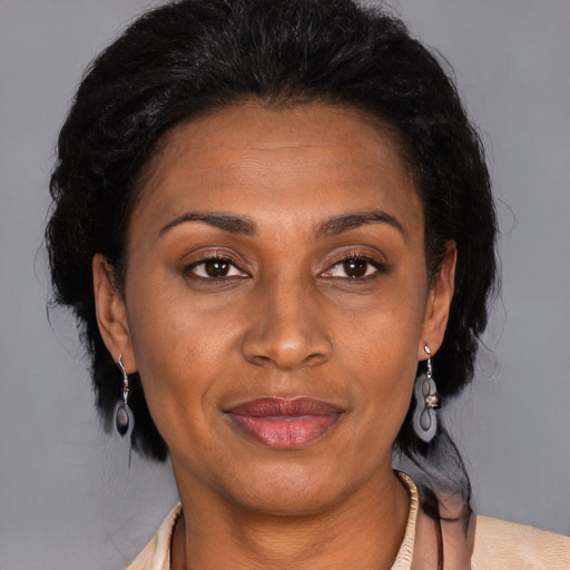 Joyful latino adult female with medium  brown hair and brown eyes
