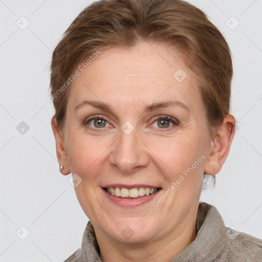 Joyful white adult female with short  brown hair and grey eyes