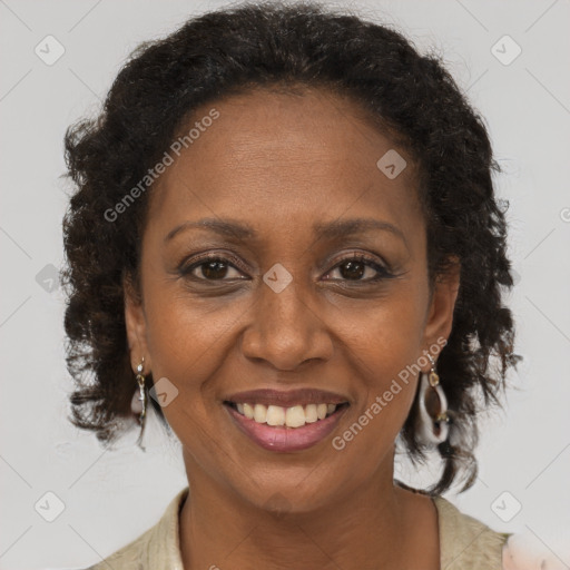 Joyful black adult female with long  brown hair and brown eyes