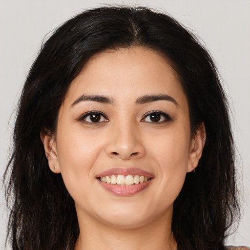 Joyful asian young-adult female with long  brown hair and brown eyes
