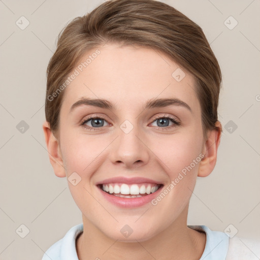 Joyful white young-adult female with short  brown hair and grey eyes