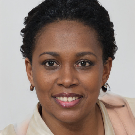 Joyful black young-adult female with short  brown hair and brown eyes