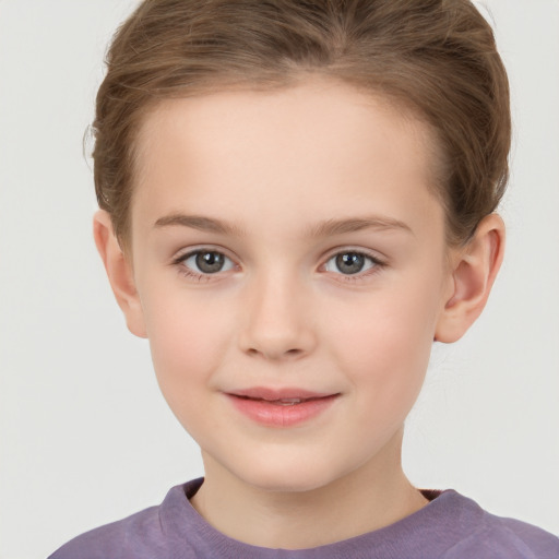 Joyful white child female with short  brown hair and brown eyes