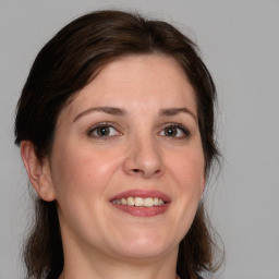 Joyful white adult female with medium  brown hair and brown eyes