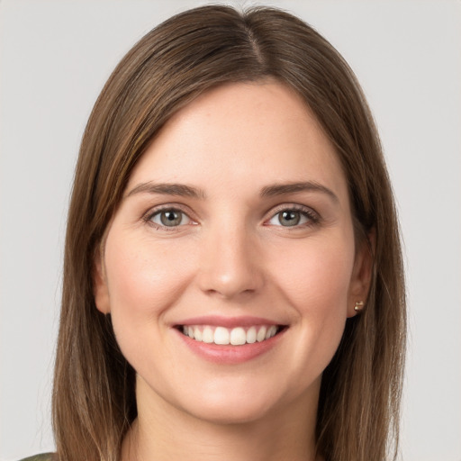 Joyful white young-adult female with long  brown hair and grey eyes