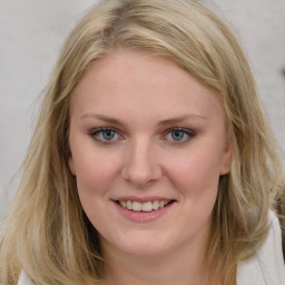 Joyful white young-adult female with medium  brown hair and blue eyes