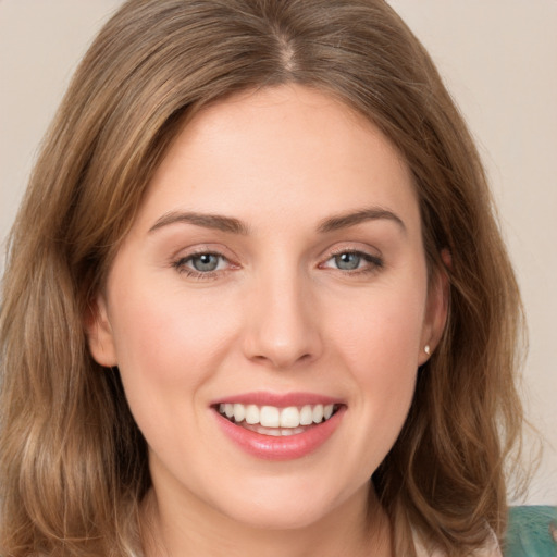 Joyful white young-adult female with long  brown hair and grey eyes