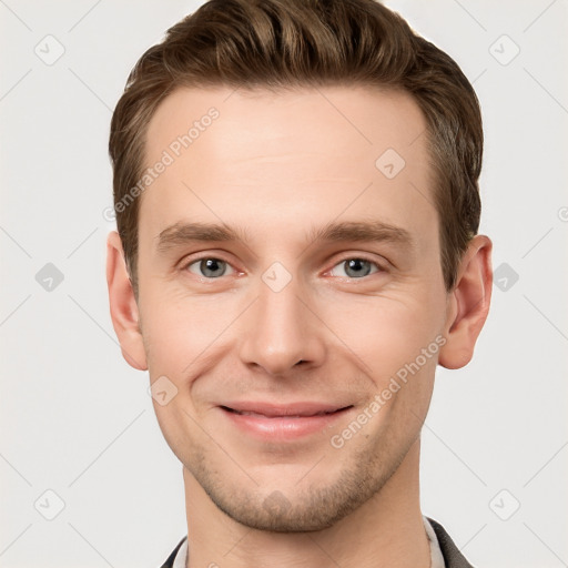 Joyful white young-adult male with short  brown hair and grey eyes