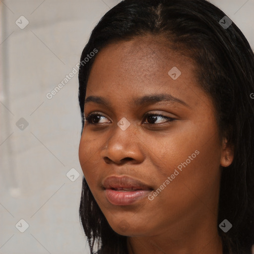 Joyful black young-adult female with long  black hair and brown eyes