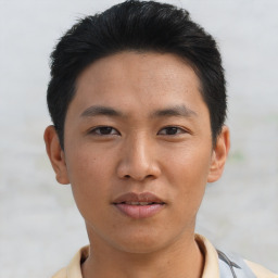 Joyful asian young-adult male with short  black hair and brown eyes