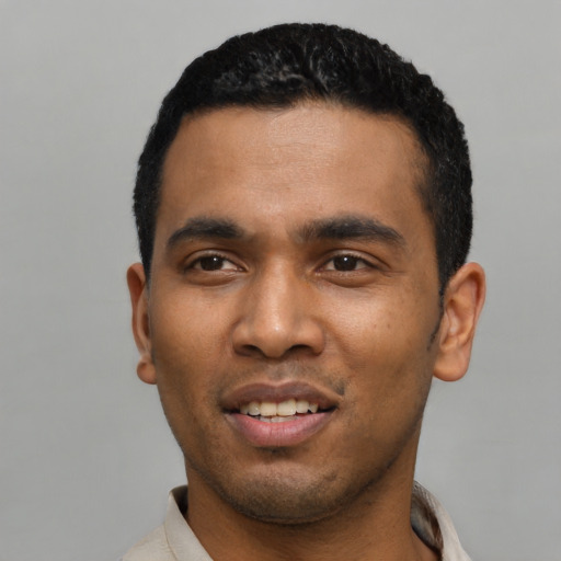 Joyful latino young-adult male with short  black hair and brown eyes