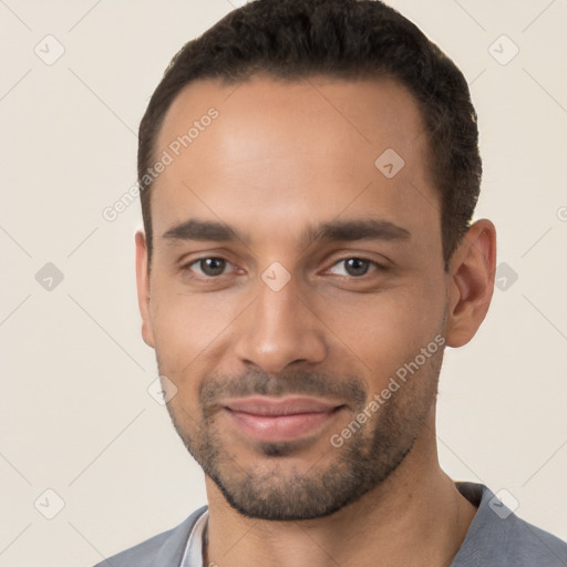 Joyful white young-adult male with short  black hair and brown eyes