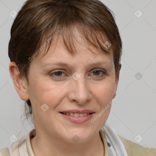 Joyful white adult female with short  brown hair and grey eyes