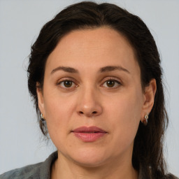 Joyful white adult female with medium  brown hair and brown eyes