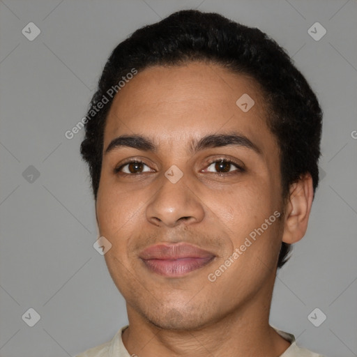 Joyful latino young-adult male with short  black hair and brown eyes