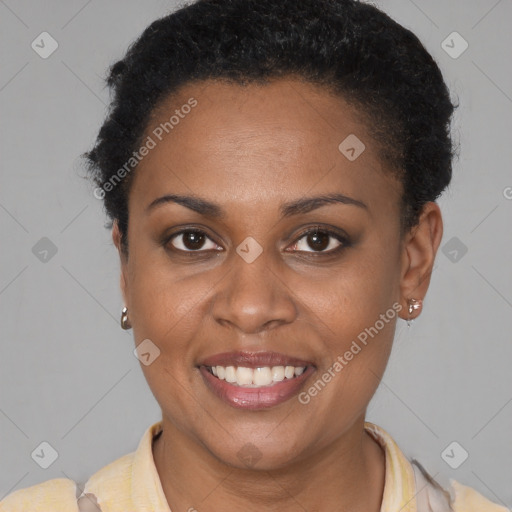 Joyful black young-adult female with short  brown hair and brown eyes