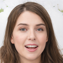 Joyful white young-adult female with long  brown hair and green eyes