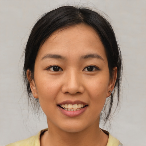 Joyful latino young-adult female with medium  brown hair and brown eyes