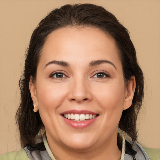 Joyful white adult female with medium  brown hair and brown eyes