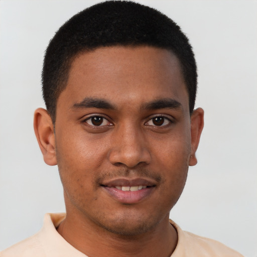 Joyful black young-adult male with short  brown hair and brown eyes