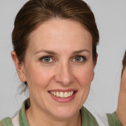 Joyful white adult female with medium  brown hair and brown eyes