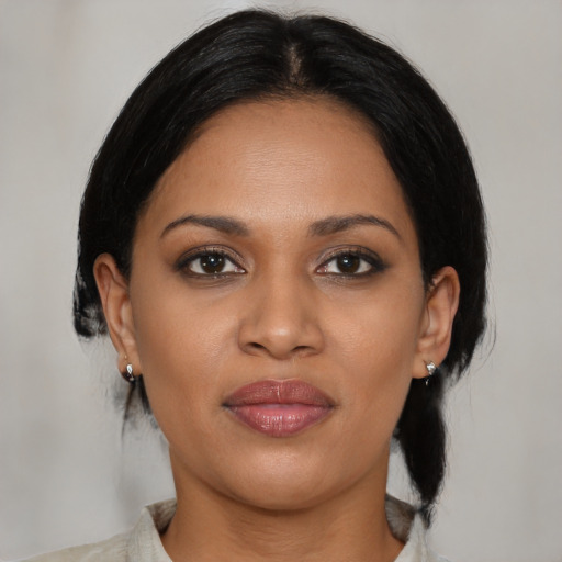 Joyful black young-adult female with medium  black hair and brown eyes