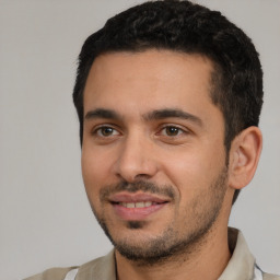 Joyful white young-adult male with short  black hair and brown eyes