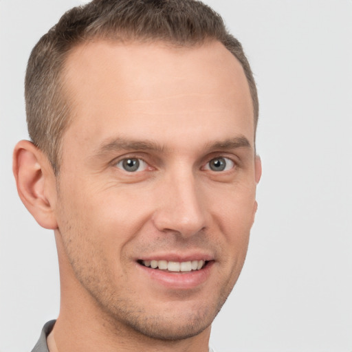 Joyful white young-adult male with short  brown hair and brown eyes