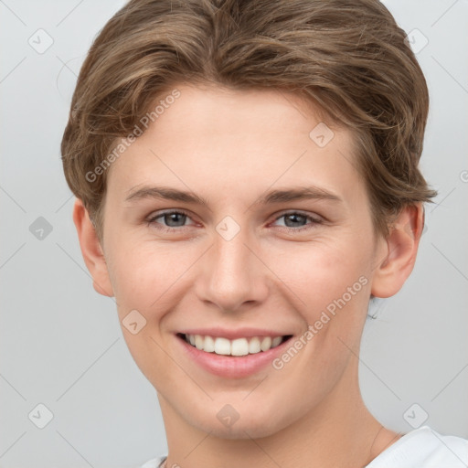 Joyful white young-adult female with short  brown hair and grey eyes