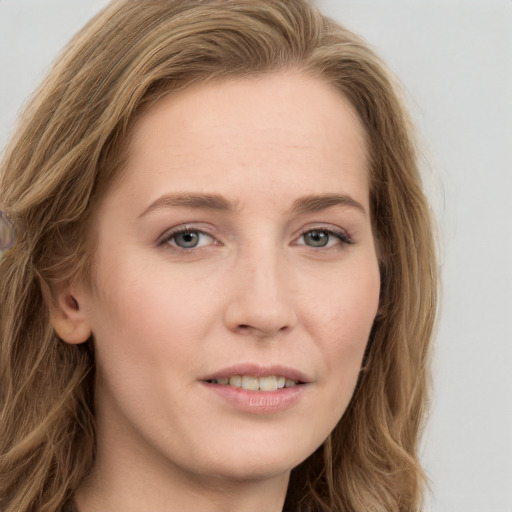 Joyful white young-adult female with long  brown hair and blue eyes