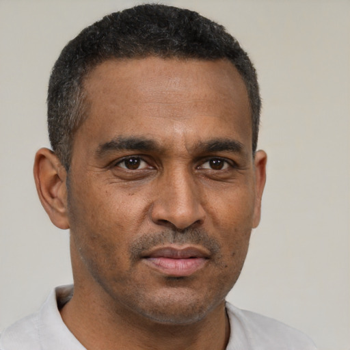 Neutral latino adult male with short  brown hair and brown eyes