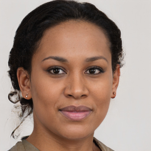 Joyful black young-adult female with medium  brown hair and brown eyes