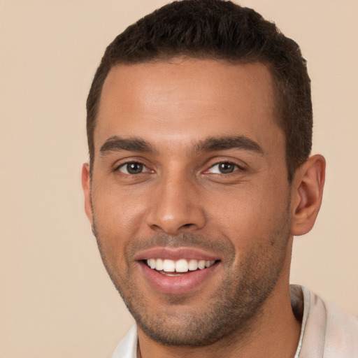 Joyful white young-adult male with short  brown hair and brown eyes