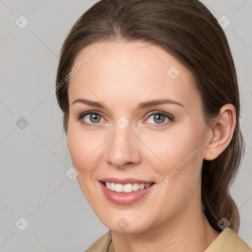 Joyful white young-adult female with medium  brown hair and grey eyes