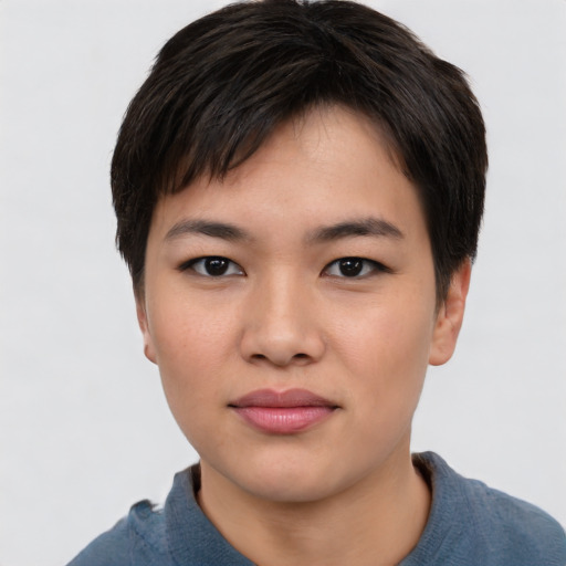 Joyful asian young-adult female with short  brown hair and brown eyes