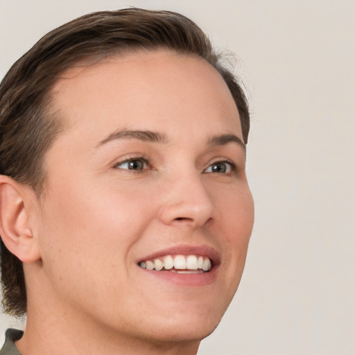 Joyful white young-adult female with short  brown hair and grey eyes