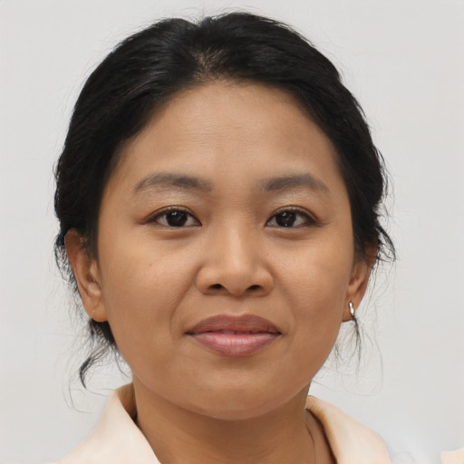 Joyful asian young-adult female with medium  brown hair and brown eyes