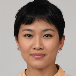 Joyful asian young-adult female with short  brown hair and brown eyes