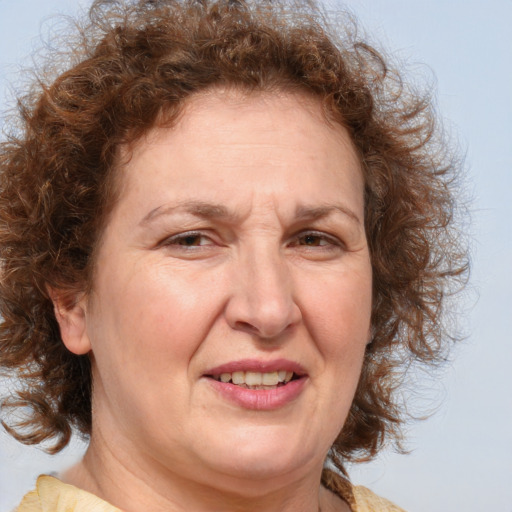 Joyful white middle-aged female with medium  brown hair and brown eyes