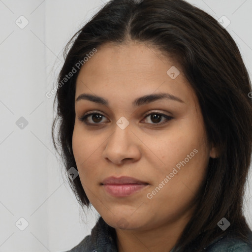 Joyful latino young-adult female with long  brown hair and brown eyes