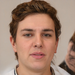 Joyful white young-adult male with medium  brown hair and brown eyes