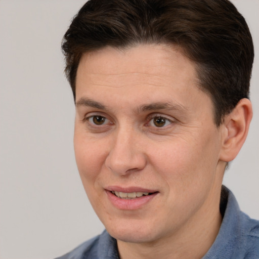 Joyful white adult male with short  brown hair and brown eyes