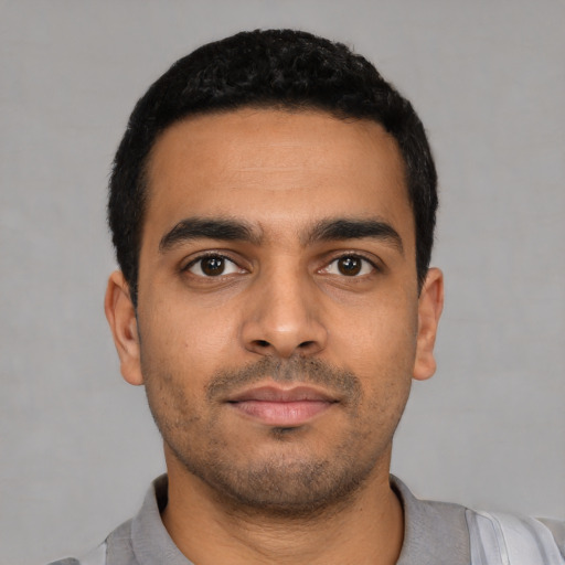 Neutral latino young-adult male with short  black hair and brown eyes