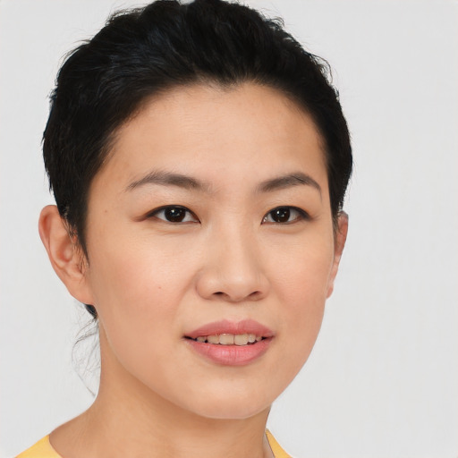 Joyful asian young-adult female with short  brown hair and brown eyes